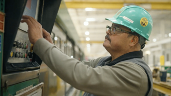 Man in hard hat working on a machine