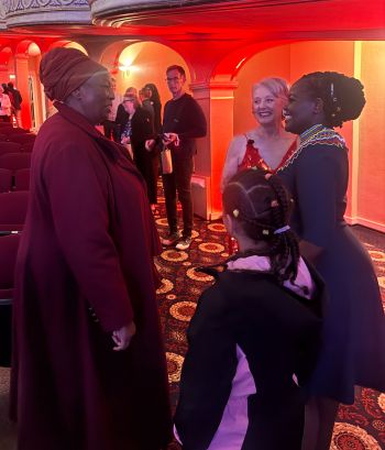 Njeri speaks with her mom and the host of the TedX after the event