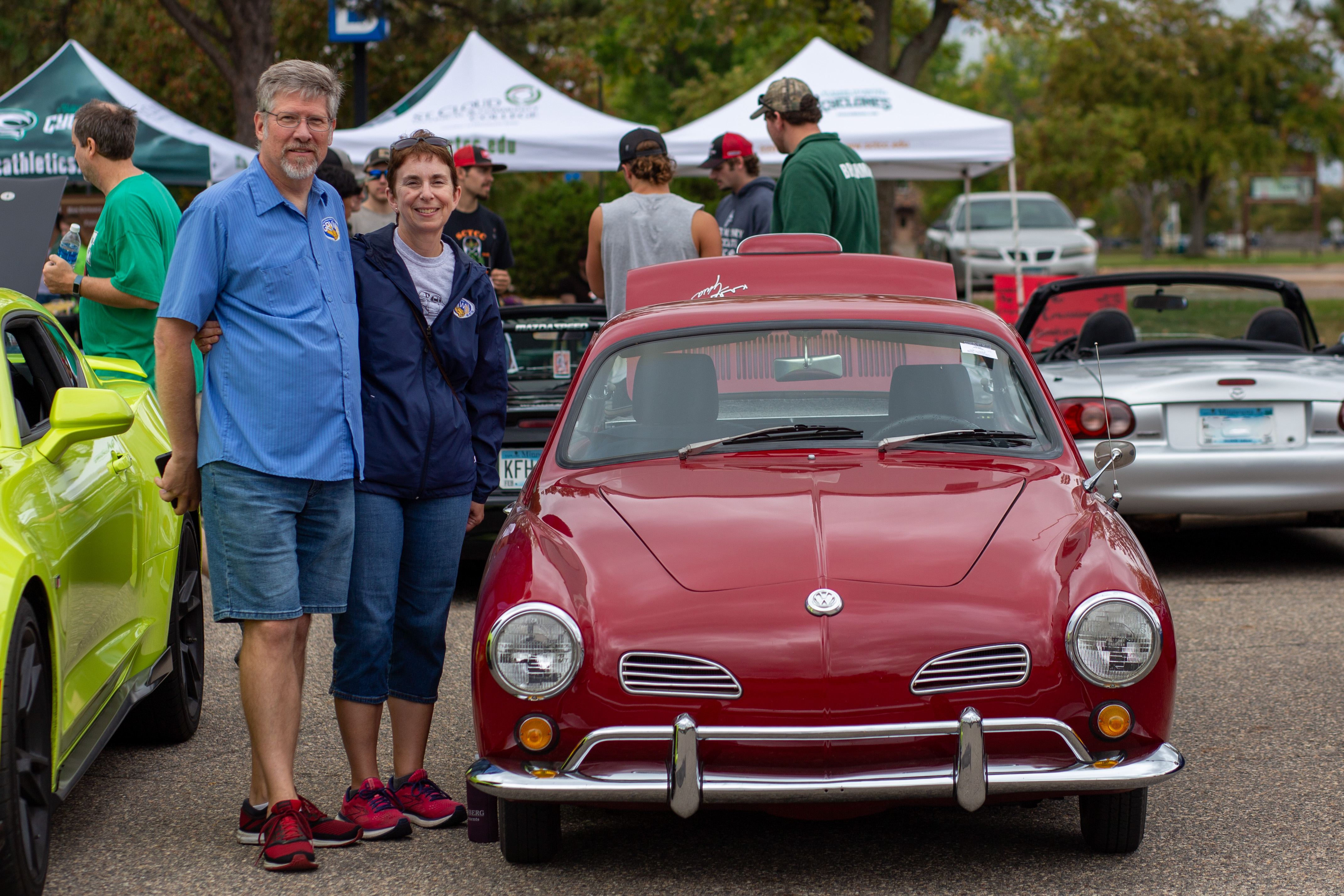 participants standing next to their car
