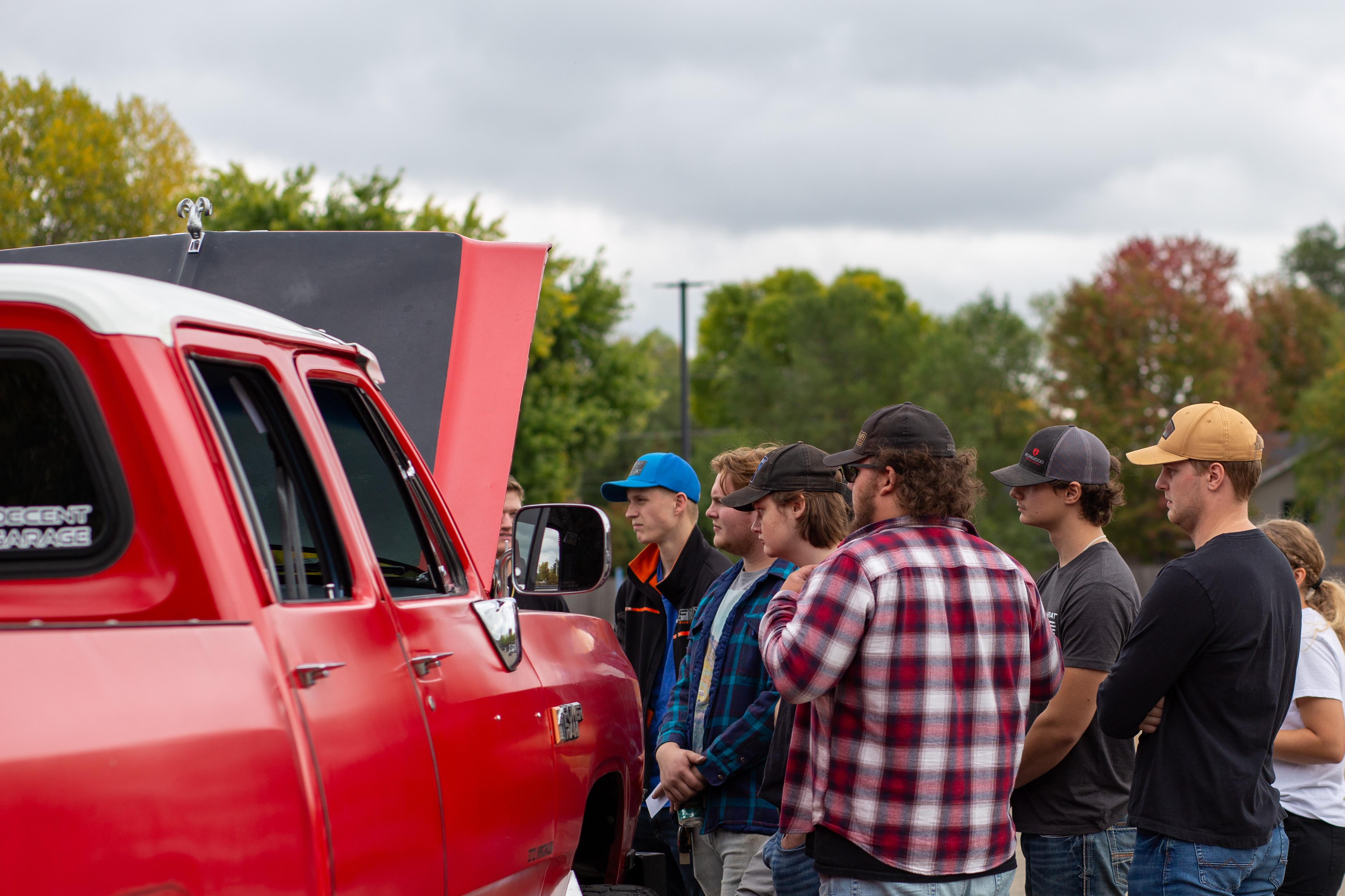 group of people looking at truck