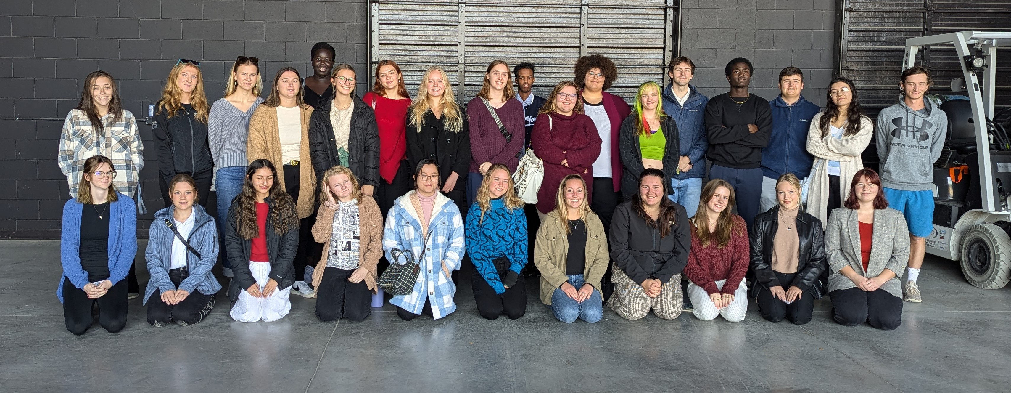 Marketing and Design students in rows at the back of the stage