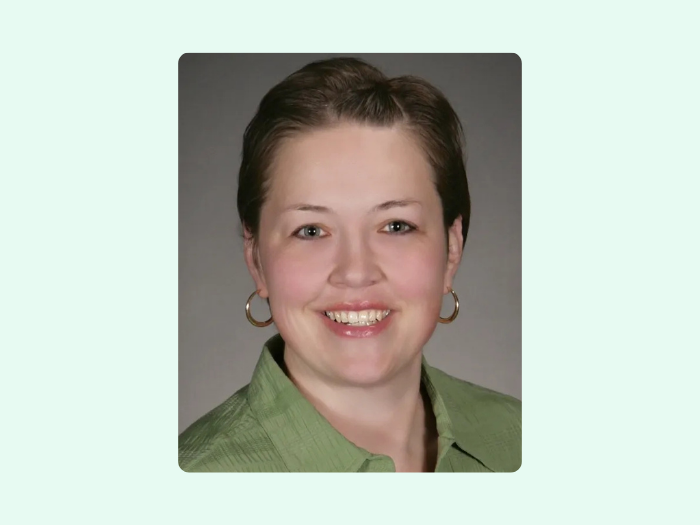 Anne Redetzke, headshot, smiling at camera