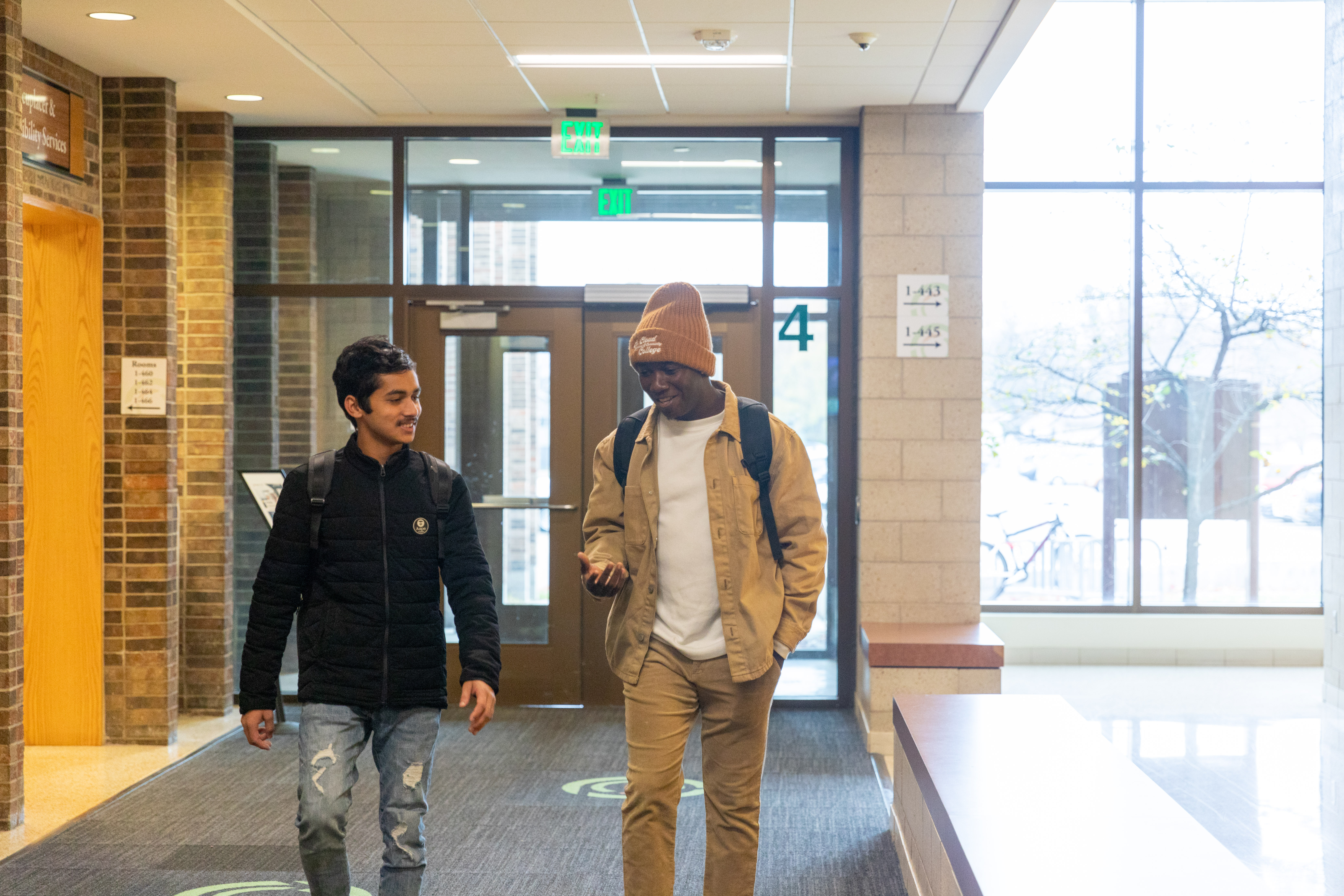 students walking in a hallway, chatting