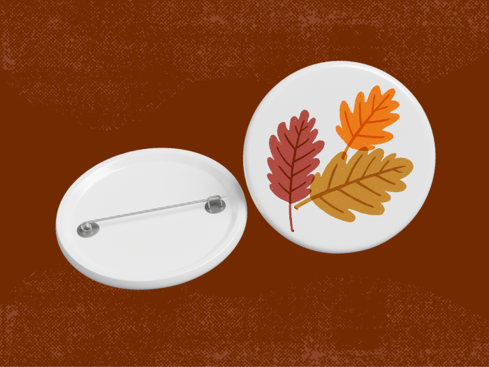 a pin button with fall leaves on it