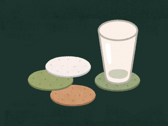 a cup sitting on a coaster with three coasters next to it