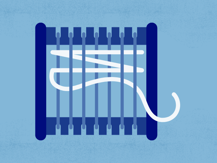 a loom with white yarn 